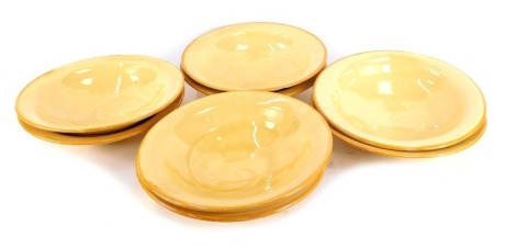 A set of eight Fenella Mallalieu studio pottery bowls, each on a light yellow ground, unmarked, 25cm diameter. (2, AF)