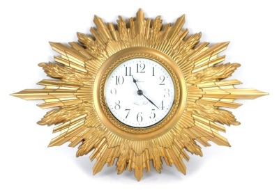 A Hanson Arden Forest gilt plaster cased sunburst clock, the circular dial bearing Arabic numerals, quartz movement, 55cm wide.