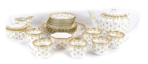 A Spode fleur de lis gold Porcelain pattern part tea service, comprising teapot, cream jug, sugar bowl, sucrier and cover, bread plate, six cups, saucers and tea plates.