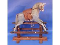 A Victorian rocking horse supported on a pine stand