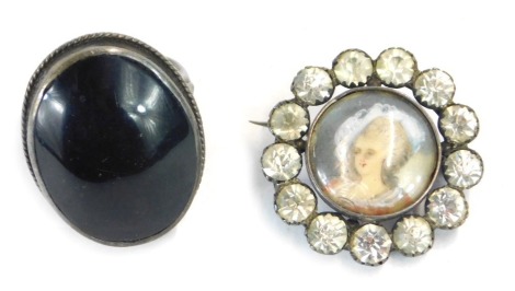 A silver dress ring, set with central dark stone possibly amethyst, and a further portrait brooch, 13.1g all in. (2)