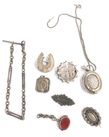 A group of Victorian silver jewellery, comprising bar brooches, lockets, and watch chains, a horseshoe shaped brooch, etc., 84.7g all in.