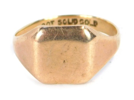 A gents signet ring, with a plain square ring head, on a yellow metal band stamped 9ct, ring size P, 3.9g all in.