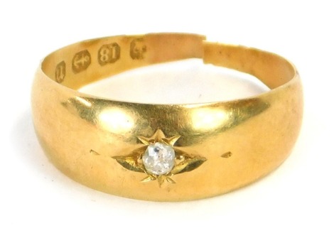 An 18ct gold diamond solitaire ring, the tiny diamond in illusion star setting, ring size L, 2.2g all in. (AF, cut)