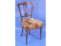 A Victorian walnut single chair with carved acanthus cresting rail and