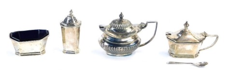 A George V silver Mappin and Webb three piece cruet set, comprising pepper, mustard and salt, with one blue glass liner, Birmingham 1925, and a silver mustard spoon, 4.15oz gross, together with a later silver plated preserve pot. (4)