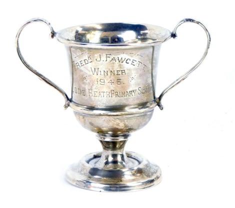 A George VI silver trophy cup, with two looped handled on a stepped foot, inscribed Fred'K J. Fawcett Winner 1946 Load Heath Primary School, Chester 1945, 1.62oz gross.