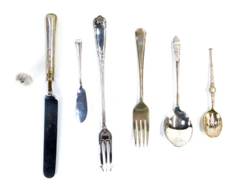 A quantity of silver cutlery, to include a commemorative silver souvenir spoon, silver handled knife and fork set, a silver floral spoon, miniature silver fish knife, pickle fork and thimble, 4.56oz gross.