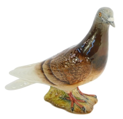 A Beswick pottery figure of a Pigeon, no 1383, impressed marks, signed Doreen to base, 15cm high.