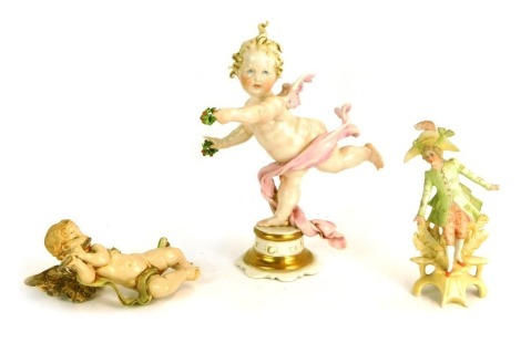 Three Continental figures, comprising a Capodimonte figure of a putto, in out stretched pose, a bisque porcelain figure of a dancer, and a plastic mounted cherub, 13cm high. (3)