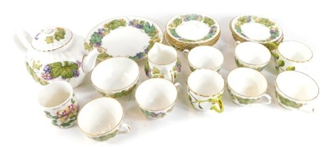 A Royal Worcester Vine Harvest pattern part tea service, comprising six cups and saucers, six side plates, cake plate, milk jug, sugar bowl, teapot, two Royal Worcester Blind Earl teacups, and a fine bone china sugar bowl. (1 tray, AF)