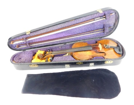 A Stradivarius Cremonensis reproduction two piece back violin, bearing label with two bows, 60cm high, in fitted case.