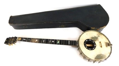 An FC Wilkes banjo, with ebonised handle and mother of pearl inlay, with ivorine tuning pegs, 91cm long, in fitted case.