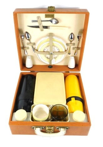 A Brexton picnic hamper, with plastic tupperware and ceramic fitted interior, possibly later, in orange travel case.