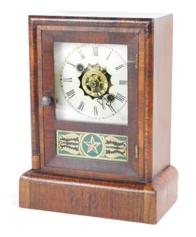 A 19thC Newhaven Clock Company American rosewood cased mantel clock, with a painted Roman numeric dial and glass star panel, 25cm high.