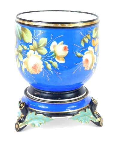 A 19thC Paris porcelain jardiniere, on a royal blue ground with flower decoration on bamboo stepped leaf base, 28cm high, 20cm diameter.