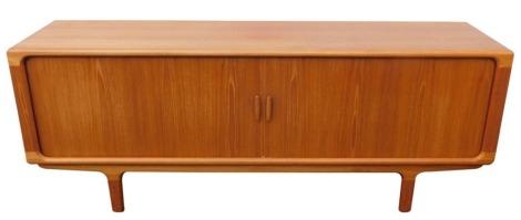 A Danish Glostrup Mobelfabrik teak sideboard, with two tambour fronted doors opening to reveal three central drawers and four recesses, raised on turned legs, 86cm high, 219cm wide, 52.5cm deep.