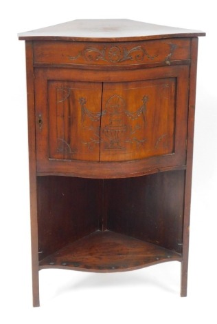 An Edwardian walnut corner cabinet, with a bow front, with carved panel door and single shelf base, 99cm high, 60cm wide, 42cm deep. (AF)