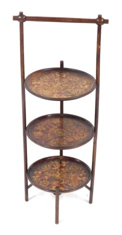 An early 20thC beech and pokerwork three tier cake stand, signed to base Mailer, 70cm high.