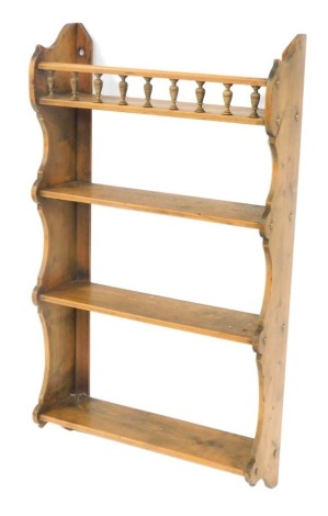 A Victorian pine hanging wall shelf, with a galleried upper shelf above three further shelves, within shaped ends, 54cm high, 48cm wide.