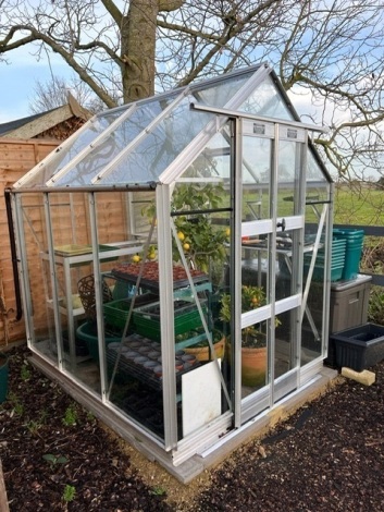 An Elite greenhouse, with automatic window openings, 5' 3" x 6'. Sale Note: Buyer to dismantle and collect no later than 31st January from a property approx 3 miles from The Bourne Auction Rooms.