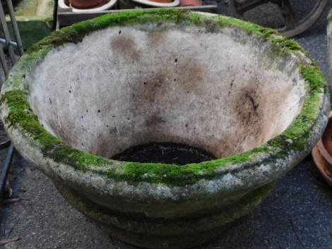 A reconstituted stone planter, of tapering form, 60cm diameter.