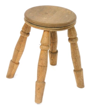 A late 19th/early 20thC elm milking stool, 30cm high.