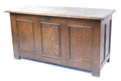 An 18thC oak coffer, with three panelled front terminating in stiles, 67cm high, 128cm wide, 51cm deep.