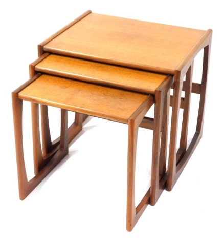 A nest of three G-Plan style teak coffee tables, the largest 50cm high.