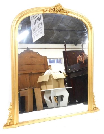 A gilt framed overmantel mirror, with arched top with shell cap moulding and swags, 130cm high, 110cm wide, 5cm deep.