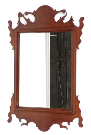 A fret framed mahogany wall mirror, with arched swan top and rectangular mirror plate, 90cm high, 60cm wide. (AF)