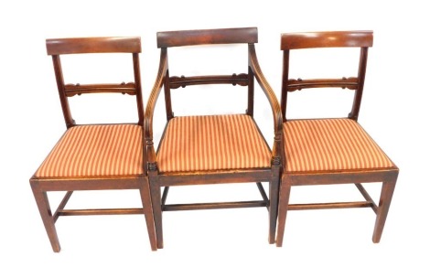 A set of three mahogany dining chairs, each with a striped drop in seat, including one carver. (3, AF)