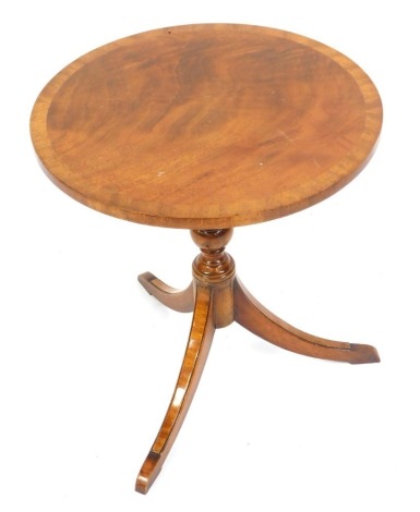 A reproduction yew wood side table, with circular top, on tripod base, 55cm high, 50cm diameter.