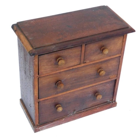 A 20thC mahogany apprentice piece cabinet, with arrangement of two short and two long drawers, on block base with bun handles, 48cm high, 48cm wide, 24cm deep.