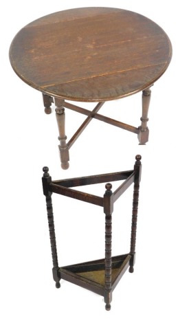 An oak drop leaf side table and associated corner umbrella stand.