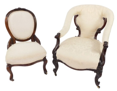 A Victorian mahogany nursing chair, upholstered in cream and white over stuffed upholstery, raised on carved cabriole legs, on castors, together with a mahogany balloon back nursing chair, similarly upholstered, raised on cabriole legs, on castors. (2)