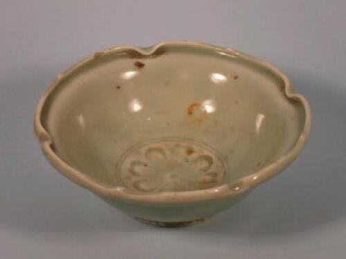 A 19thC Chinese celadon glazed bowl with a lobed edge and decorated to