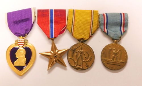 Four US American service medals and awards, being the Purple Heart, all services Bronze Star from 1944, Defence Service est: 28.6.41 and Airforce Good Conduct medal. (4)