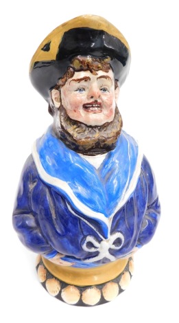 A late 19thC Wemyss pottery Toby jug, formed as a bearded sailor, polychrome decorated, with black and yellow hat and blue jacket, on a circular base, raised with shells, impressed marks beneath, 19cm high.