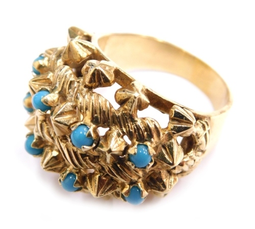 A 14ct gold cluster ring, claw set with eight turquoise on a plain shank, marked 585, size O, 10.7g all in.