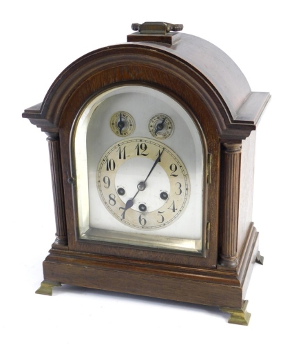 A late 19thC chiming bracket clock, with arched plate back, 13cm Arabic dial, fast slow chime silent features, in domed case, flanked by cylindrical columns on brass feet, Westminster chime, on four gongs, hour striking, 43cm high.