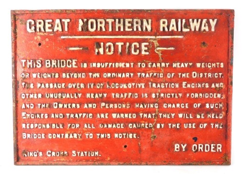 A cast iron Great Northern Railway notice, This Bridge is Insufficient to Carry Heavy Weights...Kings Cross Station, in red with raised white lettering, 50cm x 69cm.