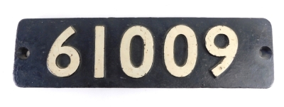 A 20thC railway train or engine number sign, 61009, in raised white numbers on black ground, 15cm x 56cm.