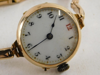 An early 20thC wristwatch, with 3cm diameter Arabic enamel dial in an unmarked 9ct gold case, with elasticated bracelet, in fitted case. - 2