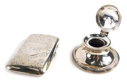 A George V silver cigarette case, with curved engine turned body and thumb mould handles with an initialled cartouche, 9cm long, with fitted interior, and a weighted silver inkwell, 5oz all in. (2)