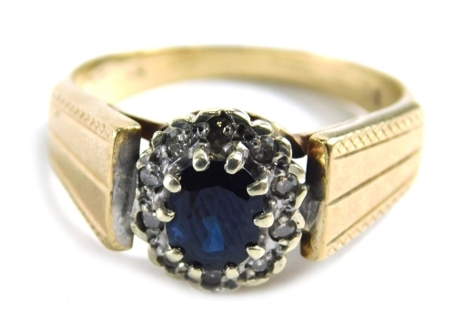 A 9ct gold sapphire and diamond dress ring, with oval sapphire in claw setting, surrounded by tiny diamonds in Art Deco style, hammered shoulders, ring size N, 3.3g all in.