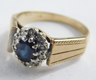 A 9ct gold sapphire and diamond dress ring, with oval sapphire in claw setting, surrounded by tiny diamonds in Art Deco style, hammered shoulders, ring size N, 3.3g all in. - 2