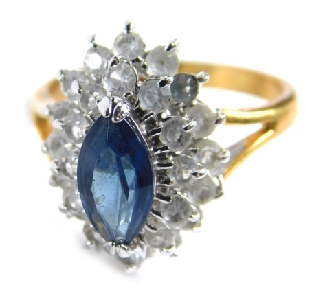 A dress ring, of two layered design with central blue paste stone set ring, on two colour plated band, ring size N.