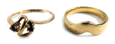 Two 9ct gold dress rings, comprising a 9ct gold wishbone dress ring, ring size K½, and a further dress ring, of scroll design, set with two blue stones, 4.4g all in.