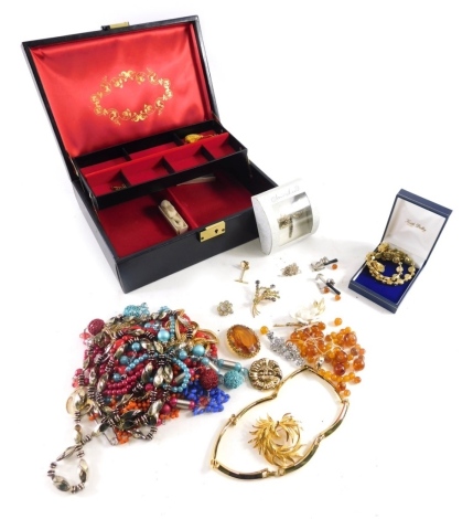 A quantity of costume jewellery, comprising costume jewellery necklaces, brooches, a brown leatherette jewellery box and contents, paste stone set brooches, pendants, beaded necklaces, etc. (a quantity)